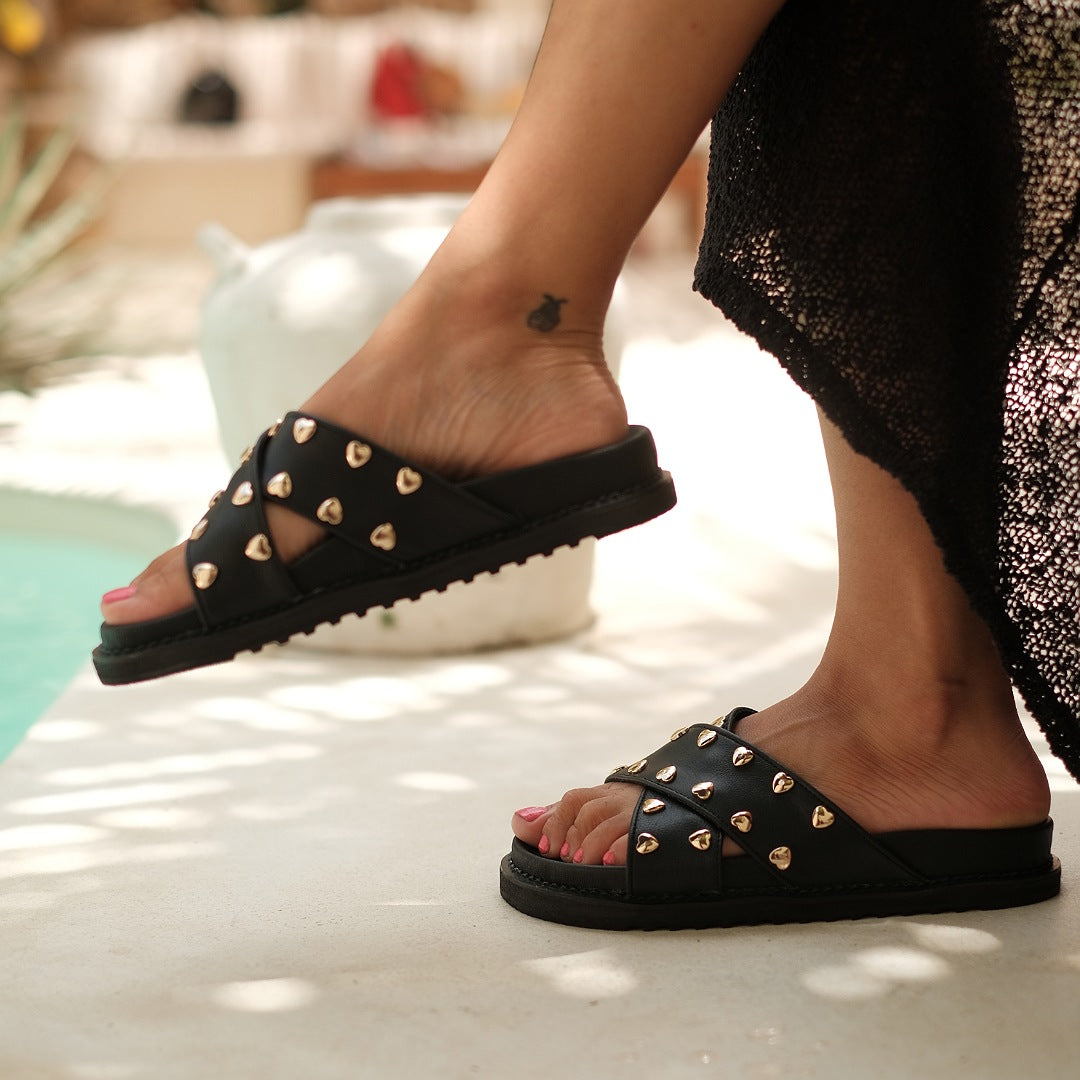 Paris Slides for Women, two leather straps, delicately decorated in golden hearts, Handmade in Bali, Pre-order, Shop for a Cause, Support SMEs, Love Local, Sustainable Fashion, Sacred Circus, Comfort, Stylish, Genuine Leather, Statement, Casual look, High-end, Footwear, Sturdy, True to Size. 